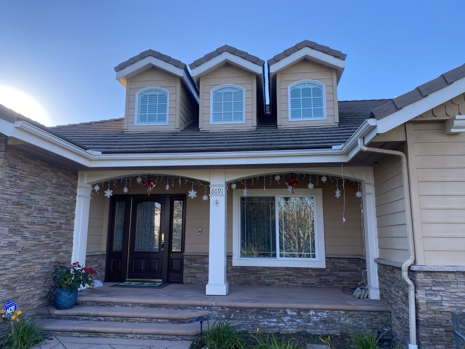 Clean two-story home exterior after pressure washing